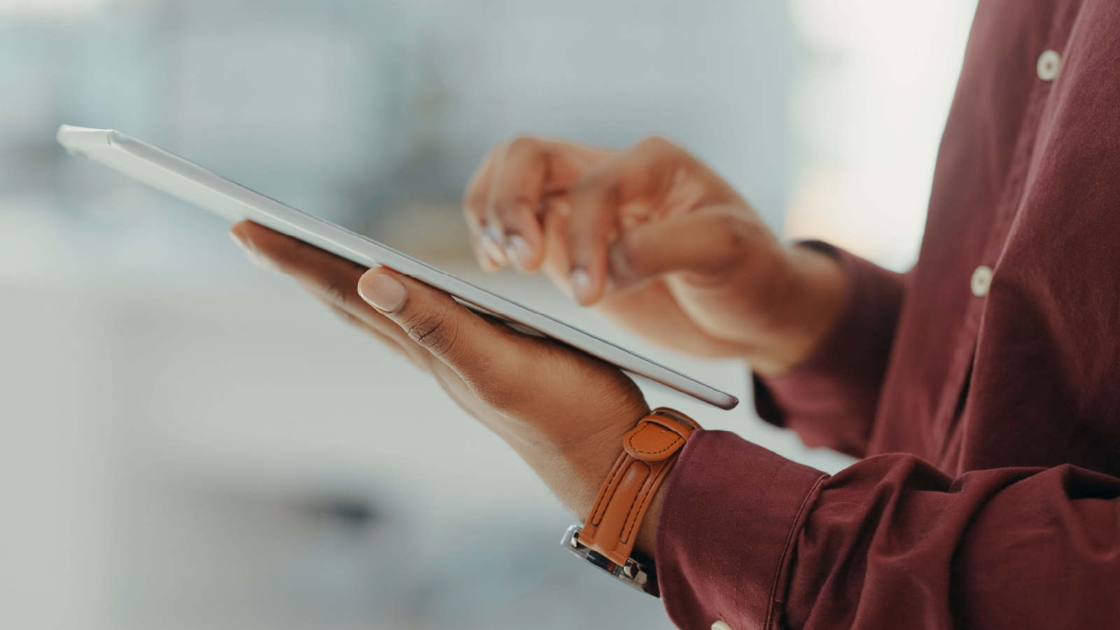 Close up image of hands using a tablet 