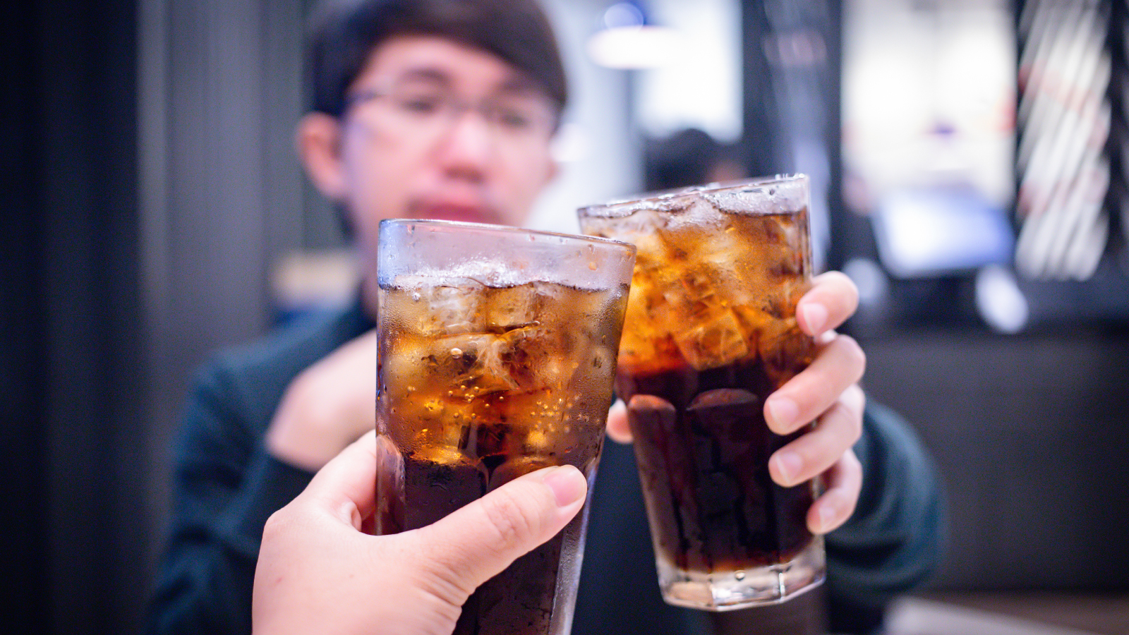 Two people performing Cheers with Coca-Cola