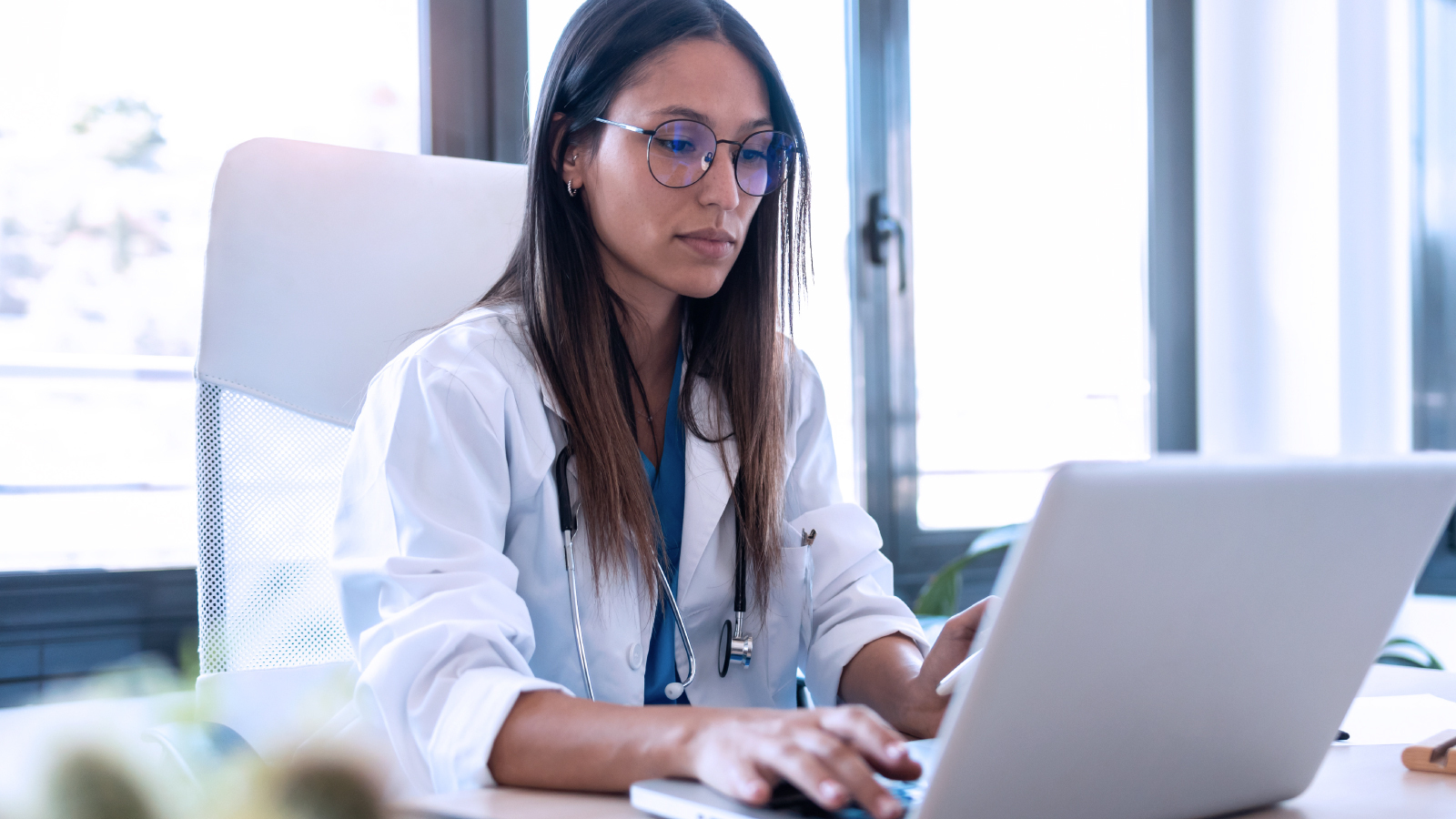 Doctor working on a laptop at her desk