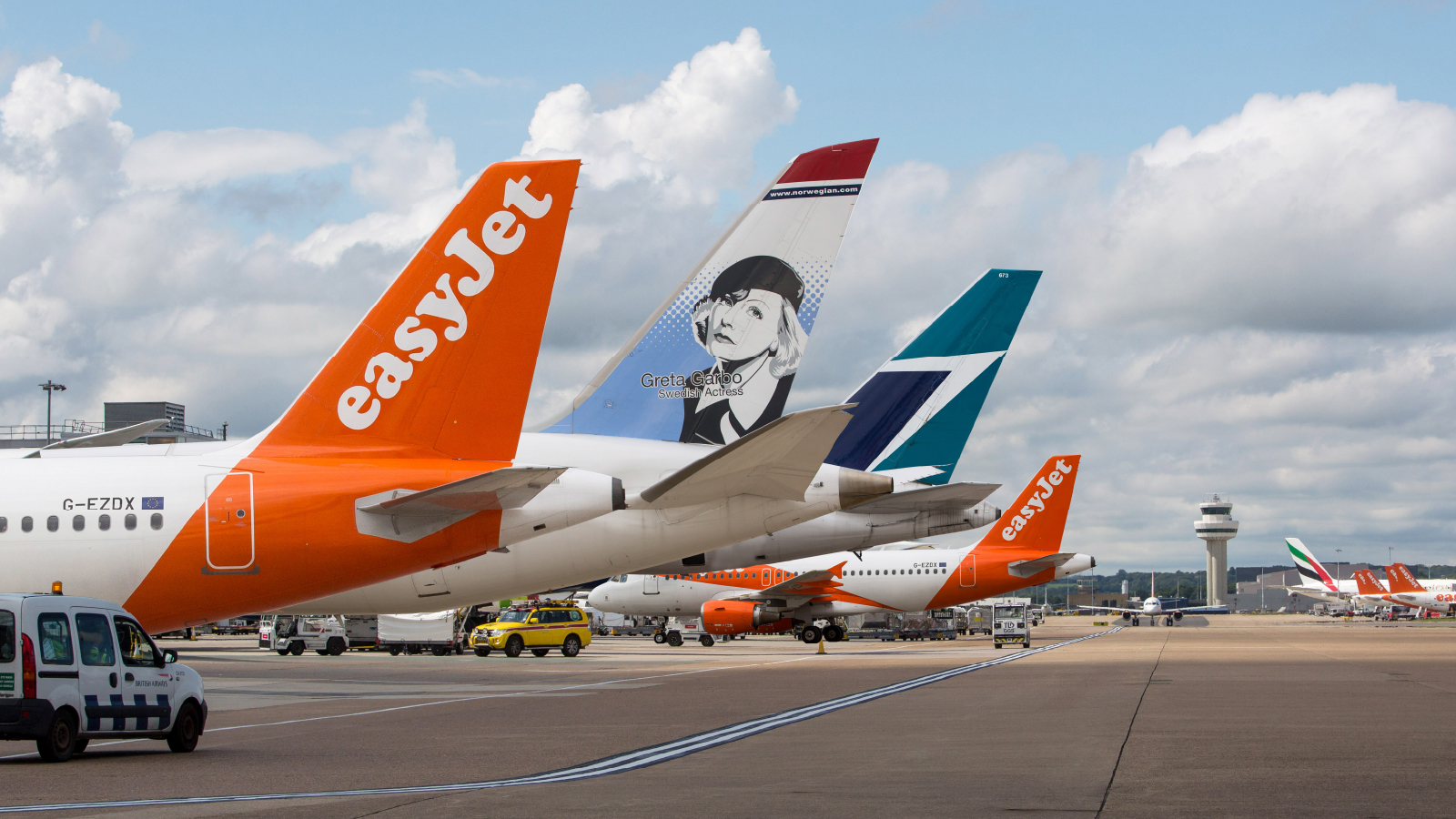 Tails of airplanes in a row parked at Gatwick