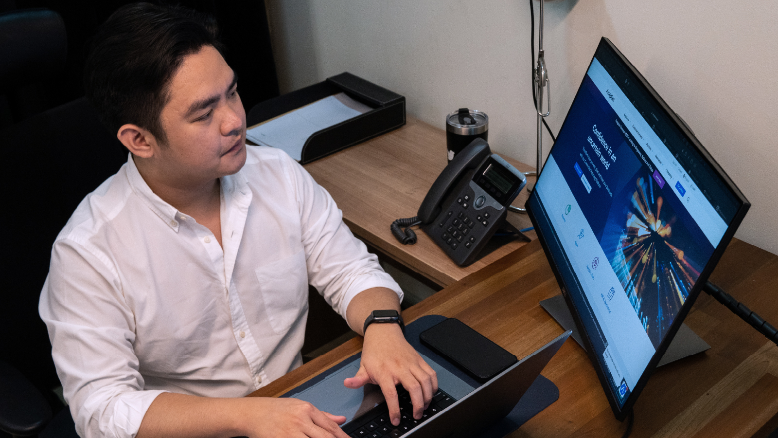 A man working in front of a computer