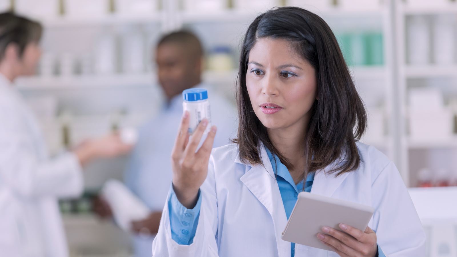 Doctors examining bottles of medication