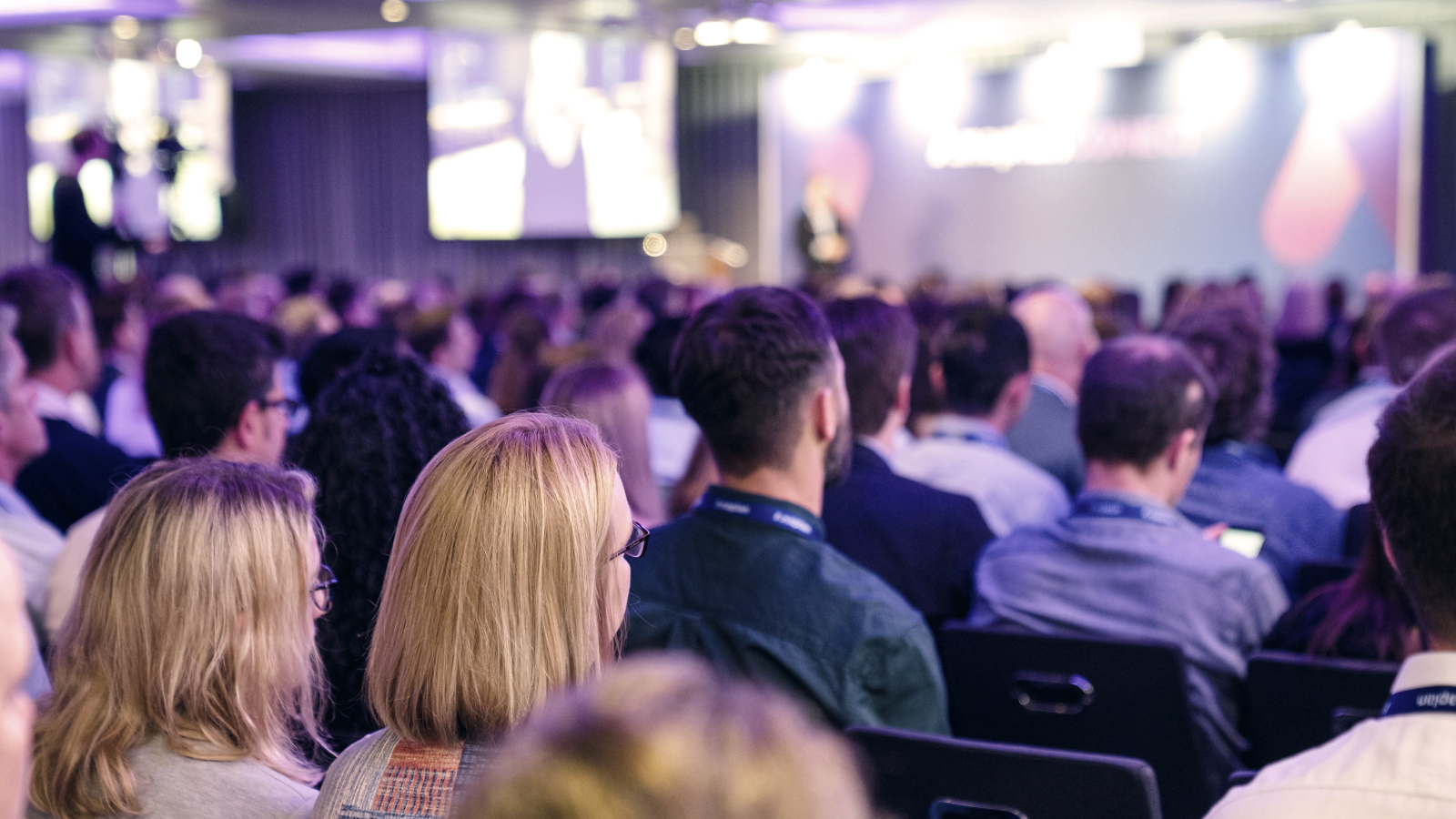 Group of people listing to a speaker