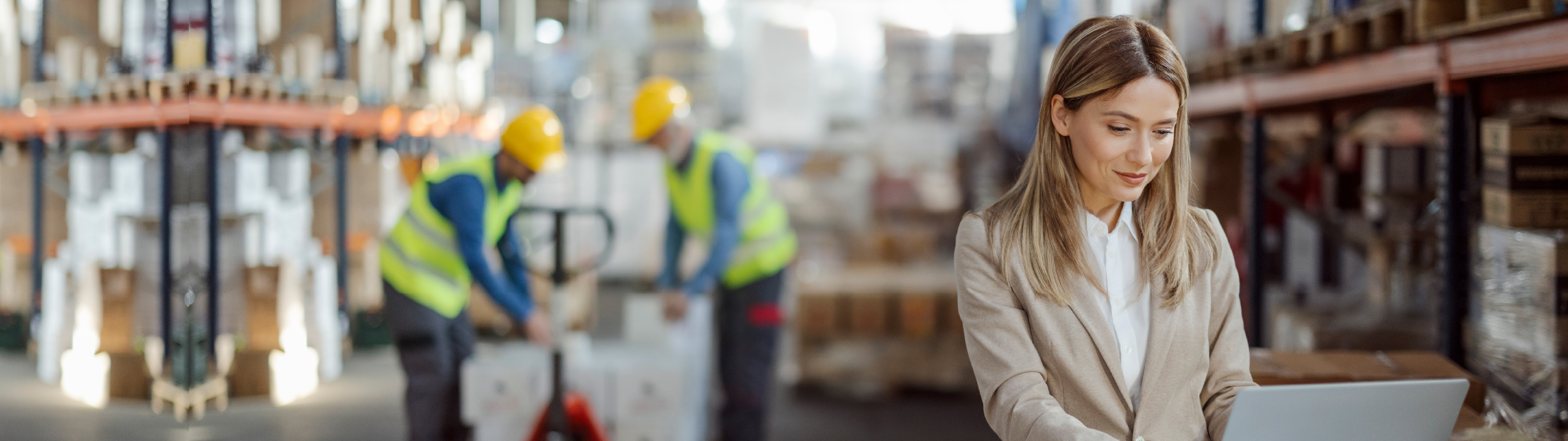 Anaplan blog on top priorities for supply chain planners. The text highlights key focus areas for supply chain professionals, with an image of a woman working on a laptop in a warehouse setting.