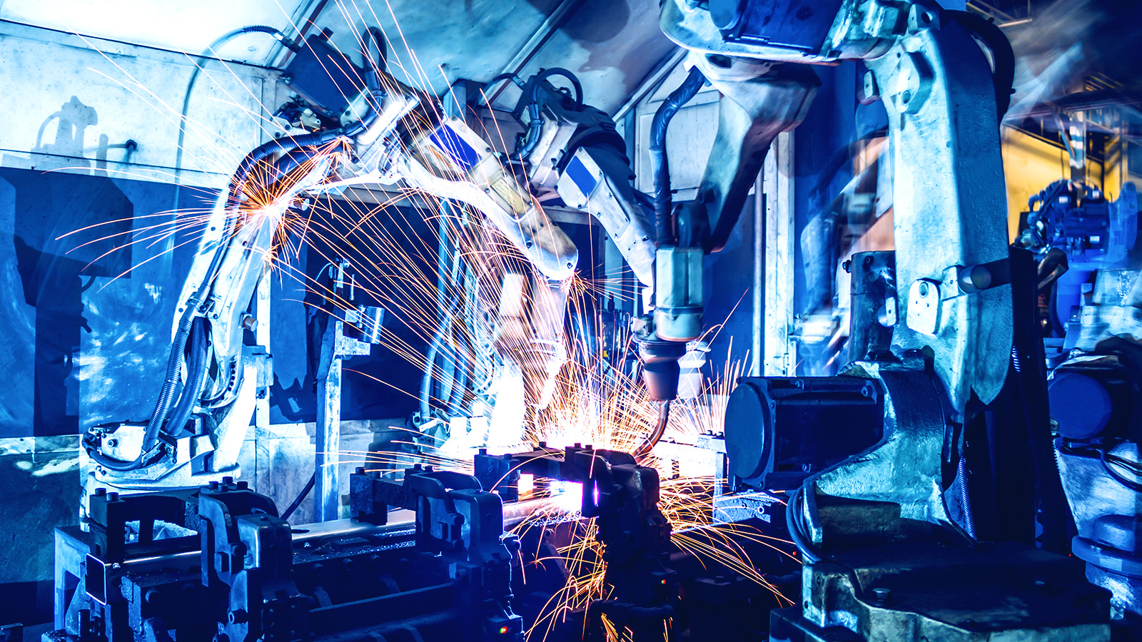 Robots building car in automotive factory