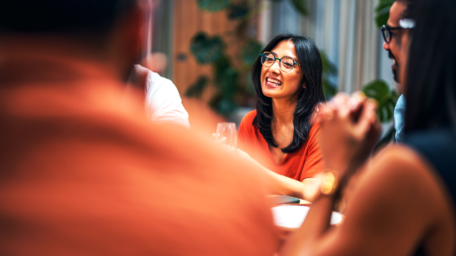 Several people seated at a table, actively discussing and exchanging thoughts in a collaborative atmosphere.