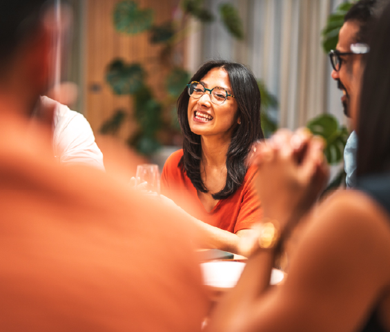 Several people seated at a table, actively discussing and exchanging thoughts in a collaborative atmosphere.