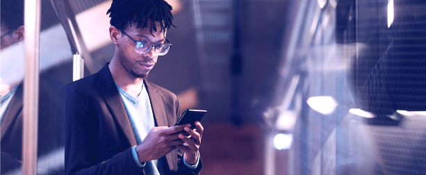 Business man in smokey office working from smartphone