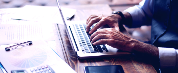 Business man typing on his laptop