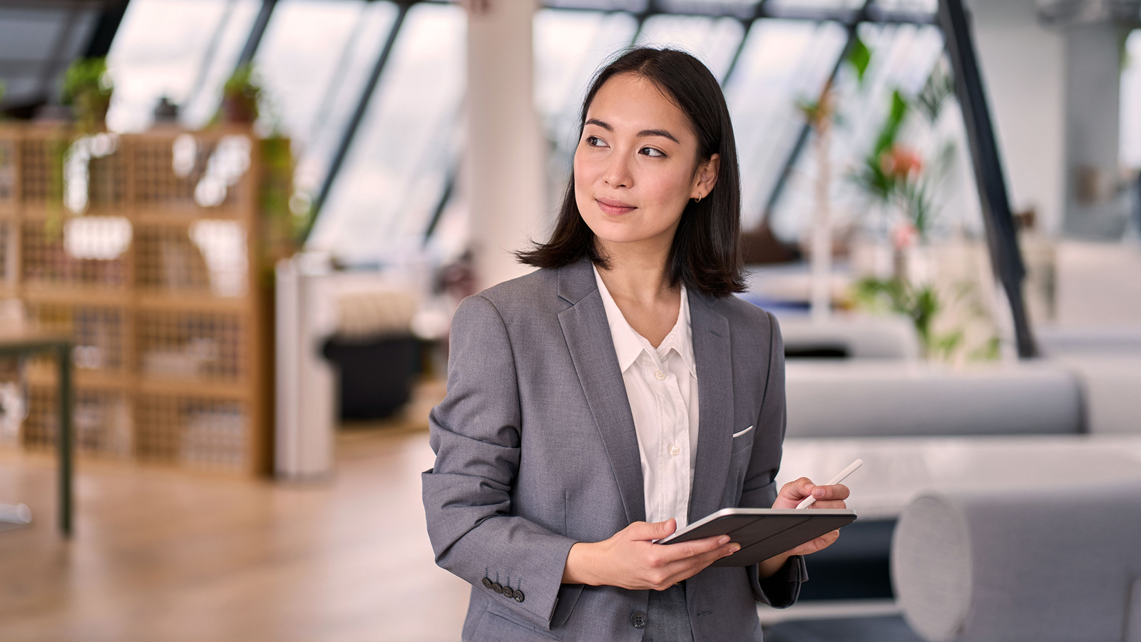 Anaplan eBook on navigating change in sales compensation strategy. The text highlights adaptability, speed, and prediction in sales compensation, with an image of a business professional holding a tablet in a modern office setting.