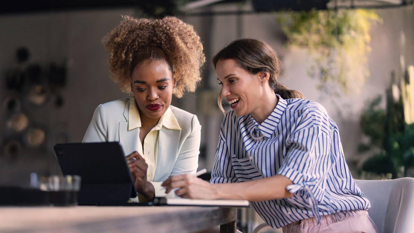  Anaplan white paper on modern finance strategies. The text highlights financial consolidation and reporting challenges, with an image of two businesswomen collaborating on a tablet in a modern workspace.