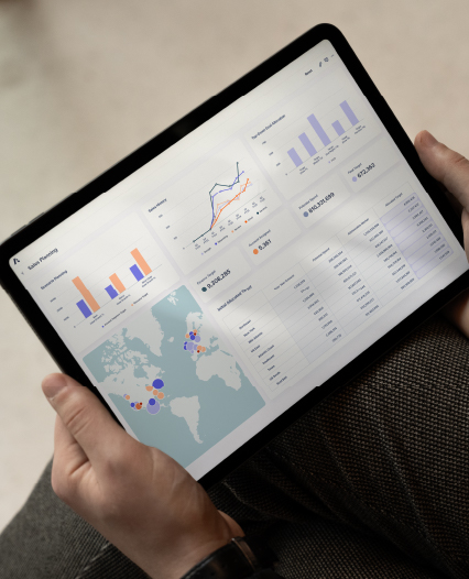 An individual engaged with a laptop, which features a graph, suggesting research or solutions tracking.