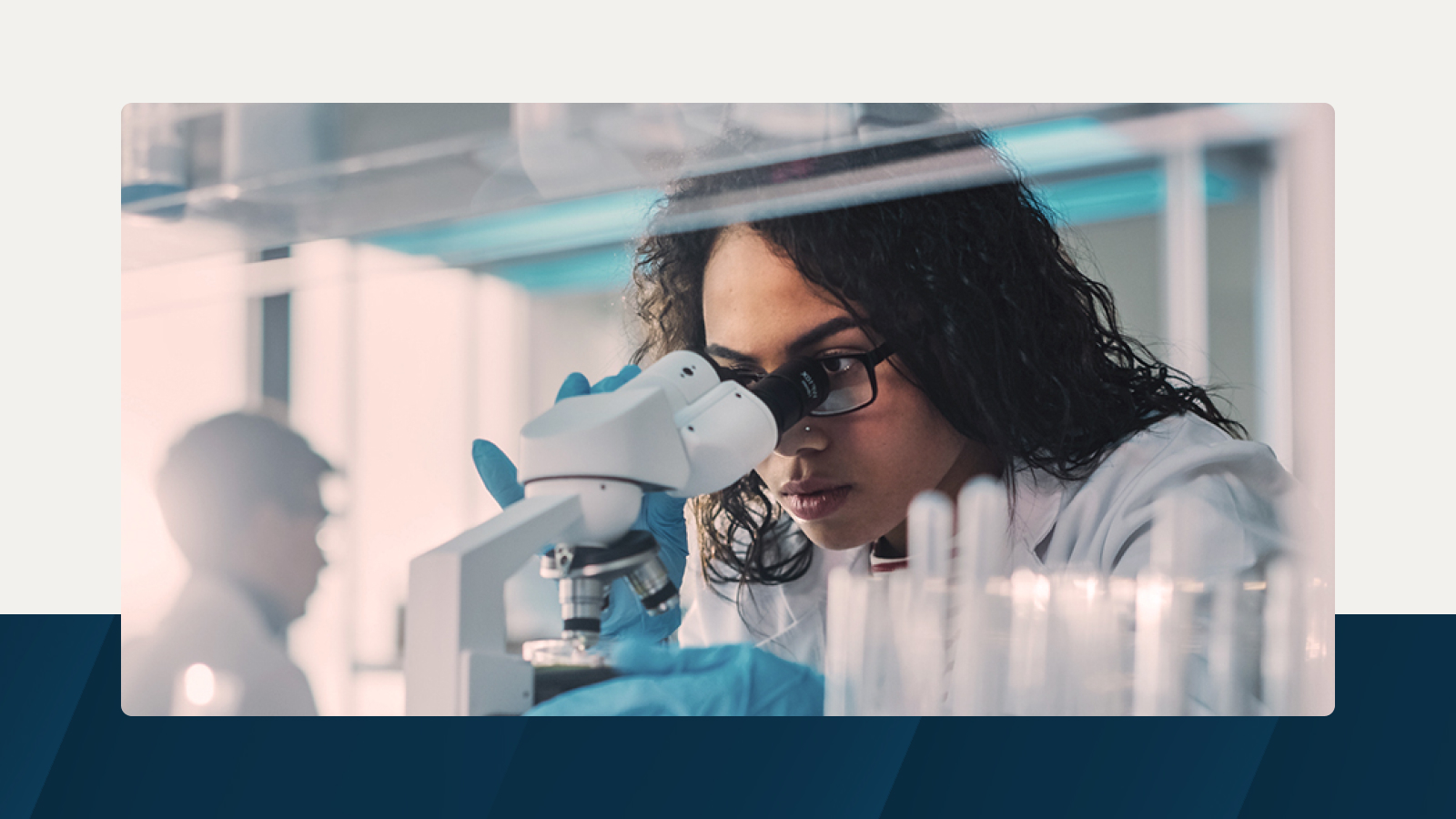 Anaplan solution brief on product forecasting in the life sciences industry. The text highlights accelerating time to market and improving operational efficiencies, with an image of a scientist examining a specimen through a microscope.