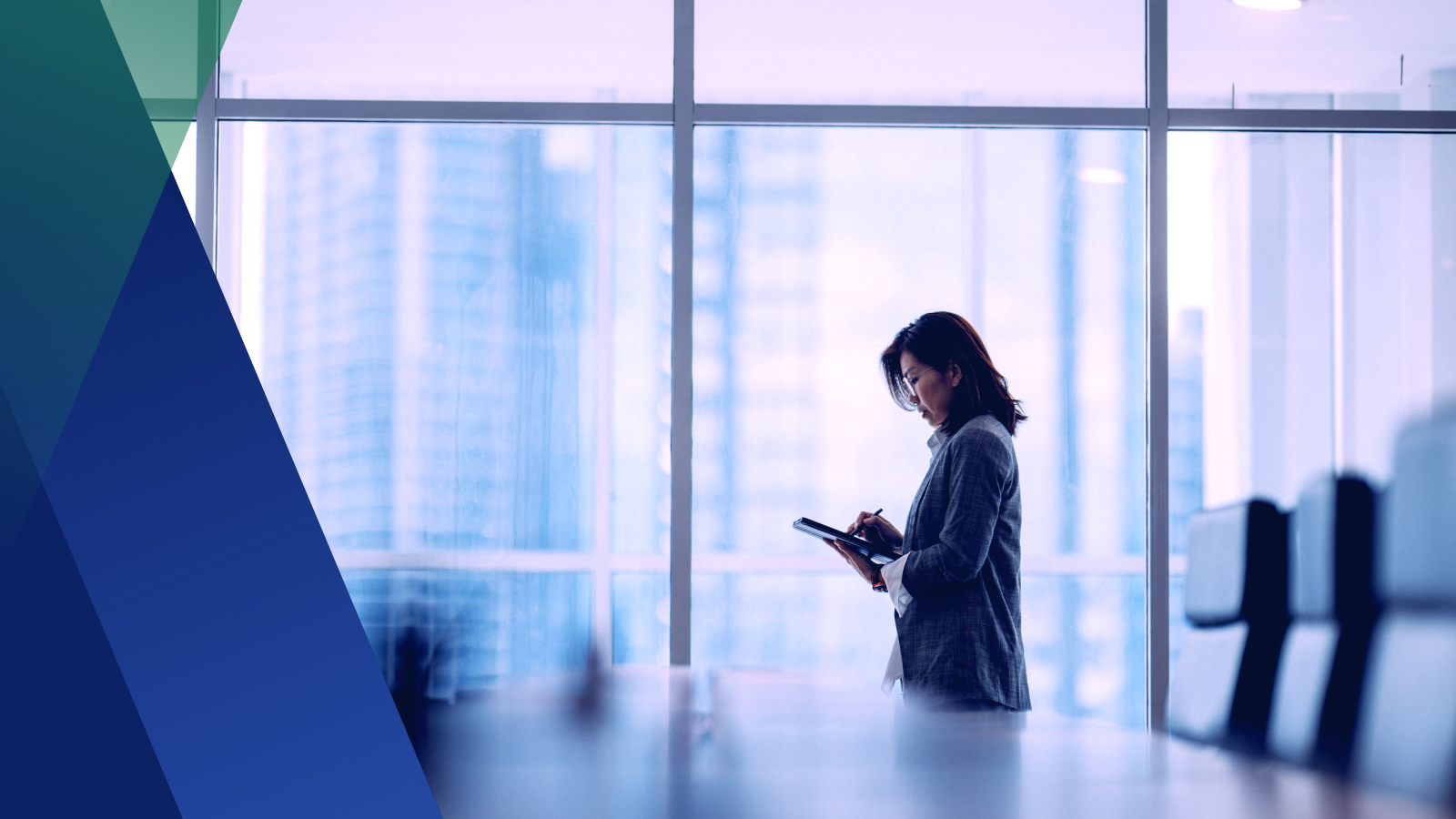 Woman in conference room looking at a tablet