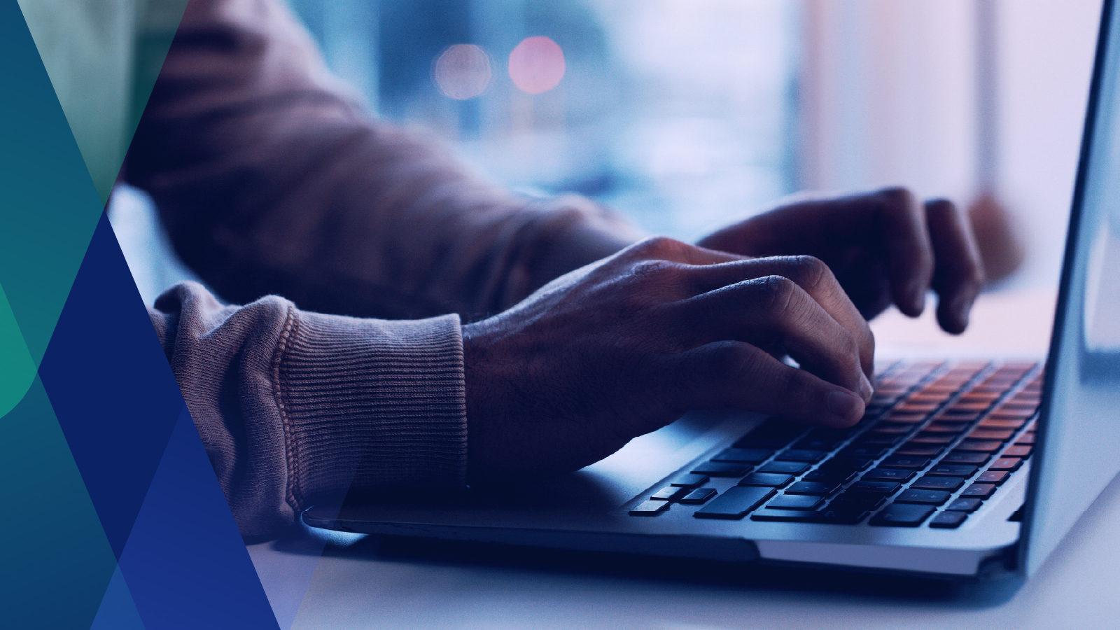 Close up image of hands typing on a laptop 