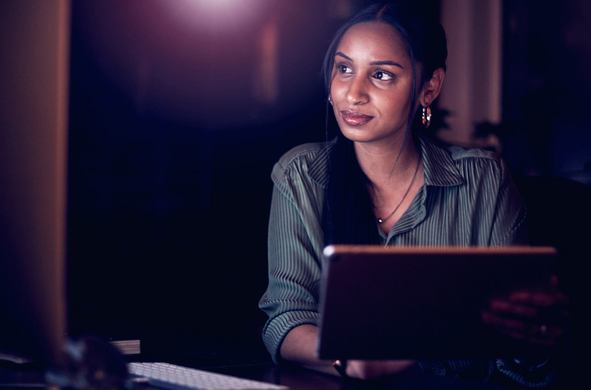 Woman looking away from tablet