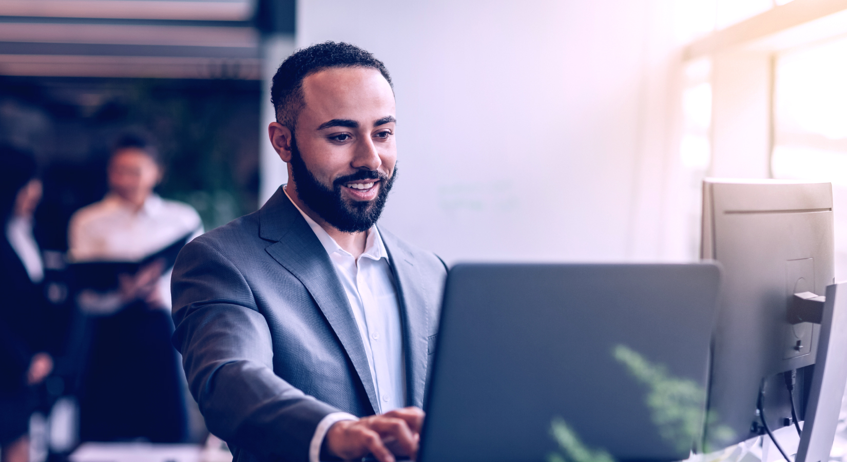 Man sitting at desk working on laptop