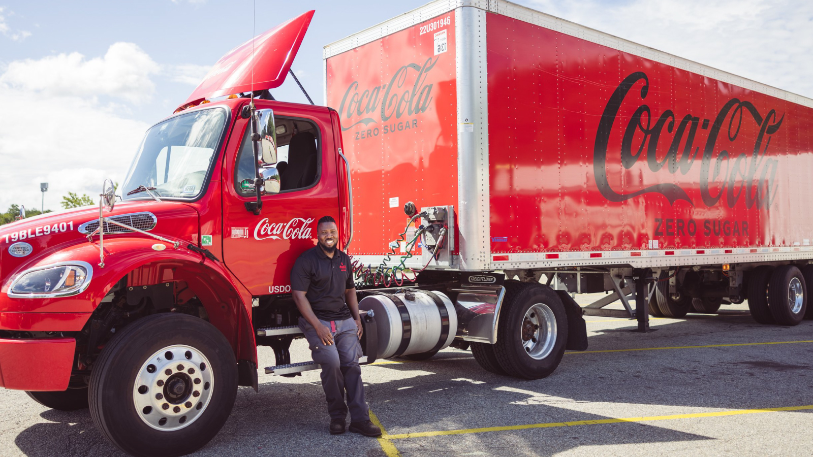 Man leaning against a Coca-Cola truck